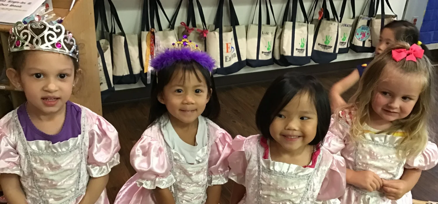 four students in princess dresses