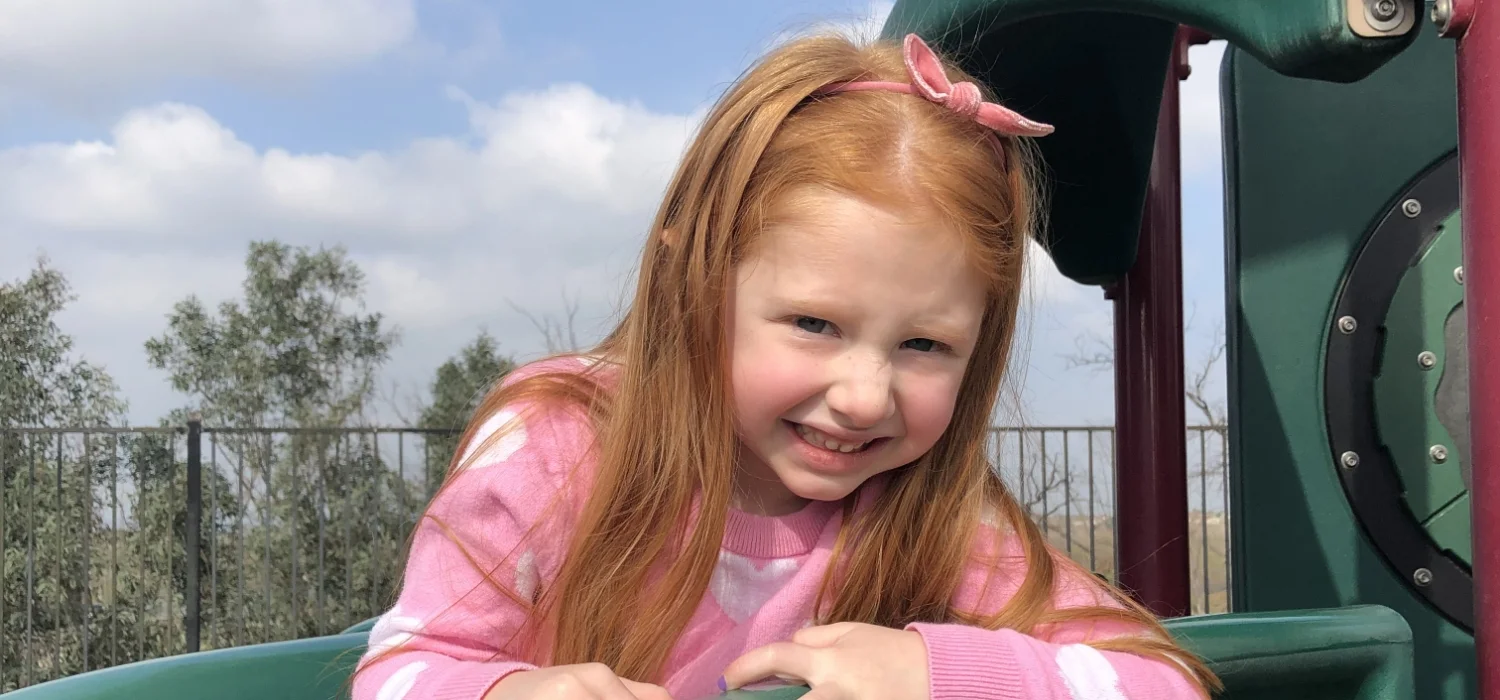 student in playground slide