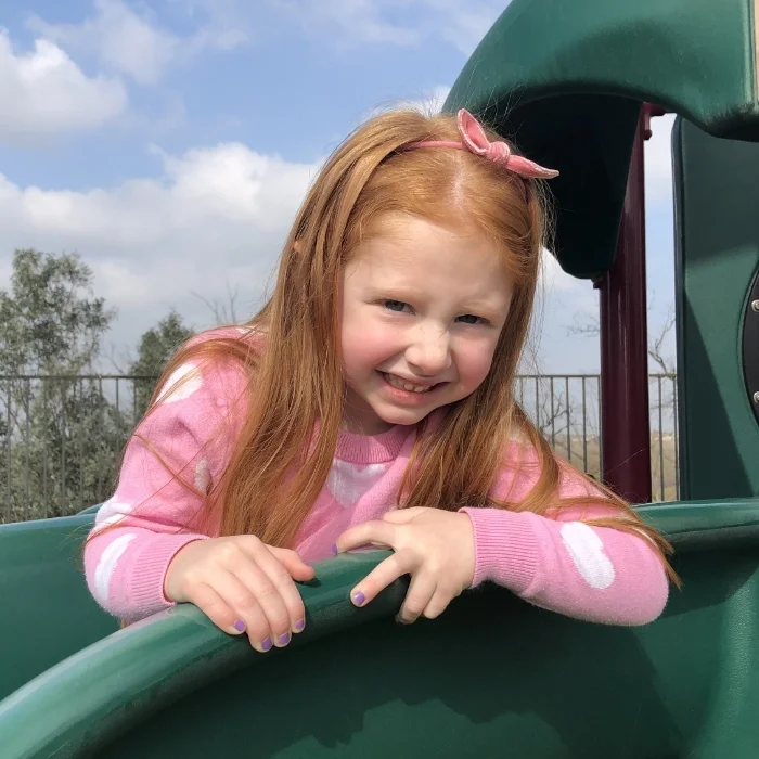 student in playground slide