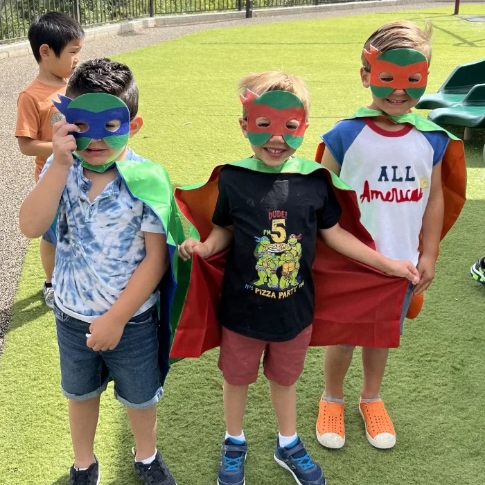 students in superhero costumes